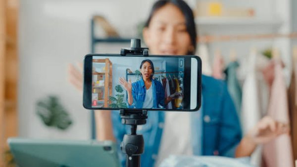 Social livestream host using audience questions, multi-guest rooms, moderation tools, and interactive show segments to keep viewers engaged