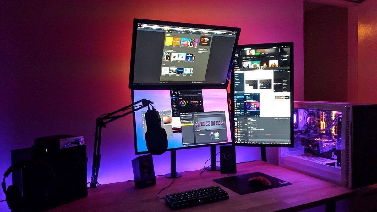 Creator building a practical live stream setup with a microphone, camera, computer, lighting, and OBS Studio