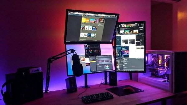 Creator building a practical live stream setup with a microphone, camera, computer, lighting, and OBS Studio